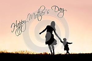 Silhouette of Mother and Baby Daughter Running and Dancing at Su