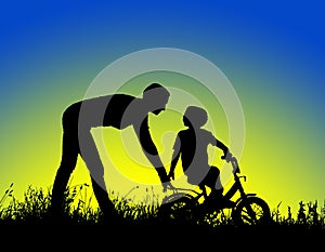 Silhouette of a mother who teaches his son to ride a bike