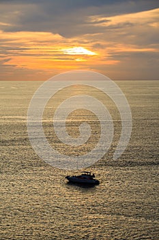 Silhouette of a motor speed boat during sunset.