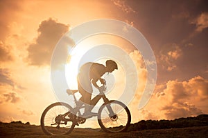 The silhouette of mountain bicycle rider on the hill