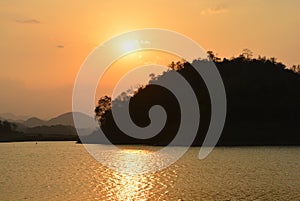 Silhouette mountain with river and sunset.