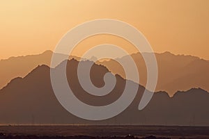 Silhouette of mountains at sunset in the evening at dusk