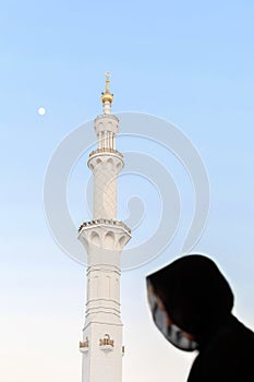 Silhouette of muslim arabic woman, covered in black abaya photo