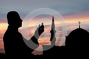 Silhouette of muslim man