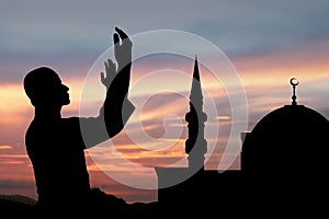 Silhouette of muslim man