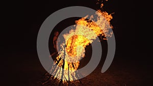 Silhouette of mystic woman in black background of fire fly flame, spark, of contour outline. Outdoor slow motion