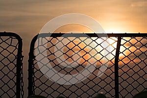 Silhouette of navy ship`s safety net at sea , sunset sky in the background