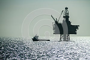 Silhouette of an Offshore Supply Vessel alongside oil platform Ringhorn in the North Sea