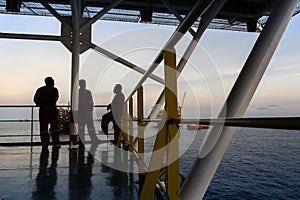 Silhouette of offshore workers at offshore Terengganu oil field during sunrise