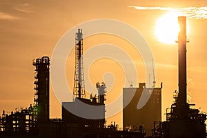Silhouette of oil and gas refinery industry plant with glitter lighting and sunrise in the morning, Factory