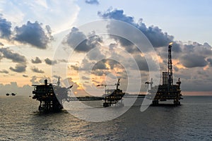 A silhouette of an oil production platforms at offshore oil field