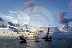 A silhouette of an oil production platforms at offshore oil field