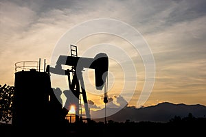 silhouette Oil pump energy industrial machine for petroleum in the sunset background