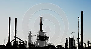 Silhouette of an oil refinery with chimneys