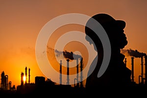 The silhouette of oil refinery worker