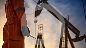 Silhouette of oil workers working in the evening