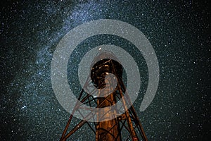 Silhouette of the Old Lighthouse against the background of the starry sky