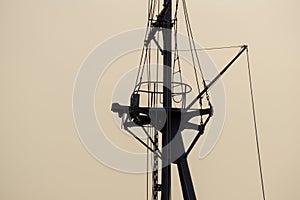 Silhouette of old navy ship`s mast and gaff