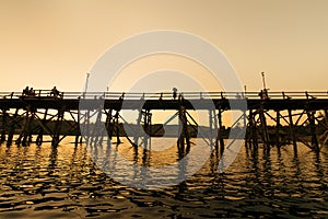 The silhouette of old wooden bridge Bridge collapse Bridge across the river and Wood bridge (Mon bridge ) at sangklaburi