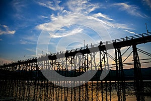 The silhouette of the old wooden bridge in Sangklaburi