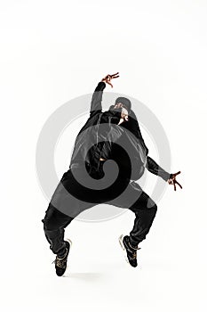 The silhouette of one hip hop male break dancer dancing on white background