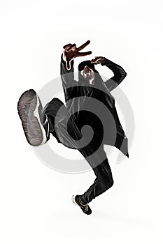 The silhouette of one hip hop male break dancer dancing on white background