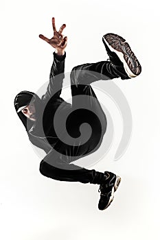 The silhouette of one hip hop male break dancer dancing on white background