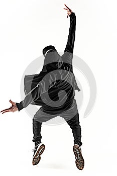 The silhouette of one hip hop male break dancer dancing on white background