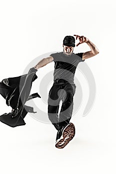 The silhouette of one hip hop male break dancer dancing on white background