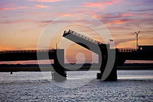 Silhouette of an open drawbridge