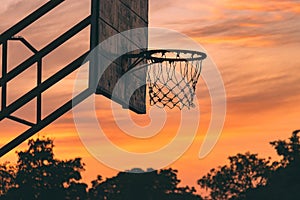 Silhouette of outdoor basketball court with dramatic sky in the sunrise morning