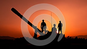 Silhouette and over the sunrise background cannon soldiers team in Thailand