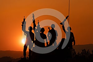 Silhouette and over the sunrise background cannon soldiers team in Thailand