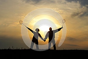 Silhouette pair of a man and a woman as husband and wife in the sky yellow sunset