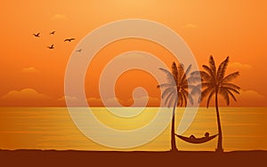 Silhouette palm tree with hammock on beach under sunset sky background