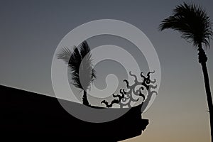 Silhouette of palm trees and the roof of Fort Provintia at sunset, Tainan, Taiwan photo