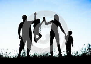 Silhouette of parents and kid having fun spending time