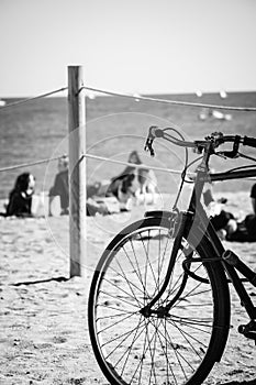 Silhouette of a parked bicycle on a beach