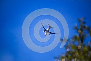 Silhouette of a passenger aircraft against a blue sky