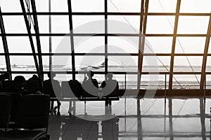 Silhouette of passengers waiting for the airplane