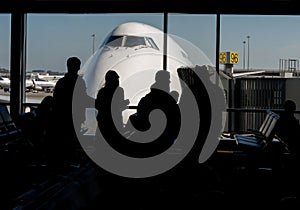 Silhouette of Passengers Waiting for Their Flight