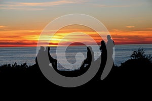 Silhouette of people enjoying the sunset, Big Sur.