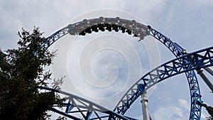 Silhouette of people having fun on the "Blue Fire" looping rollercoaster at the "Europa-Park" theme