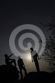 Silhouette of people on hill