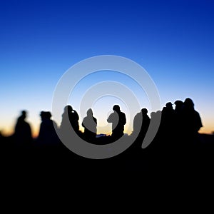 Silhouette of people on a hilltop