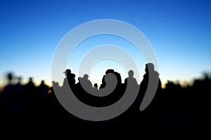 Silhouette of people on a hilltop