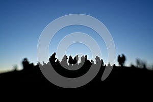 Silhouette of people on a hilltop