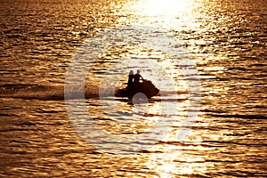 Silhouette of people on jet-ski