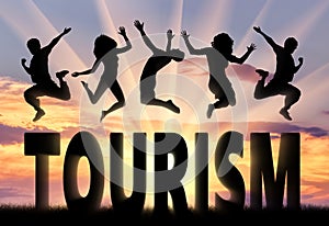 Silhouette people jumping over the word tourism