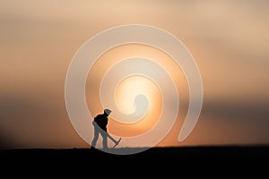 Silhouette people mining on sky sunset background.